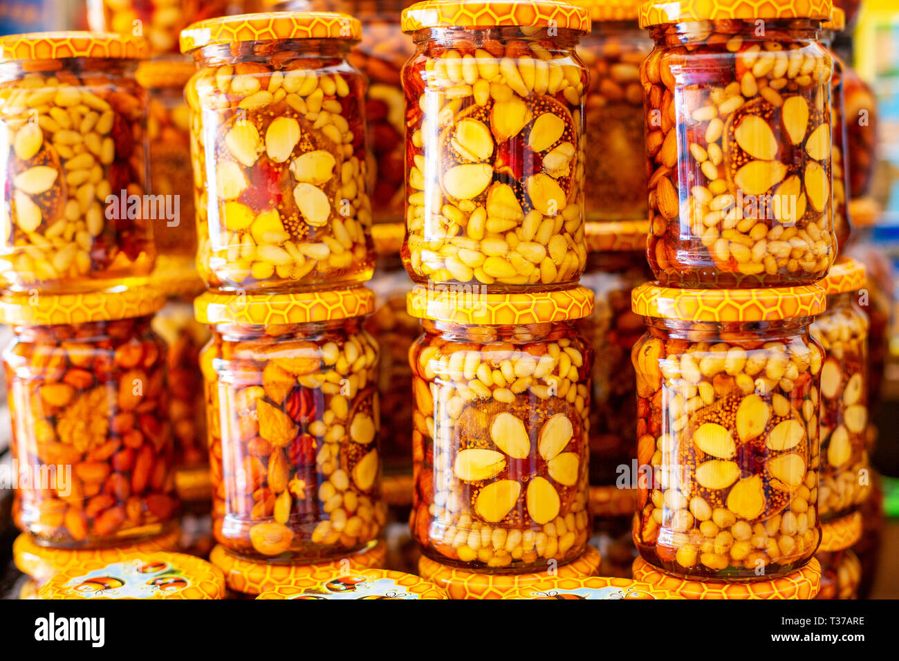 assorted nuts in a jar of honey, nutritious food Stock Photo Alamy