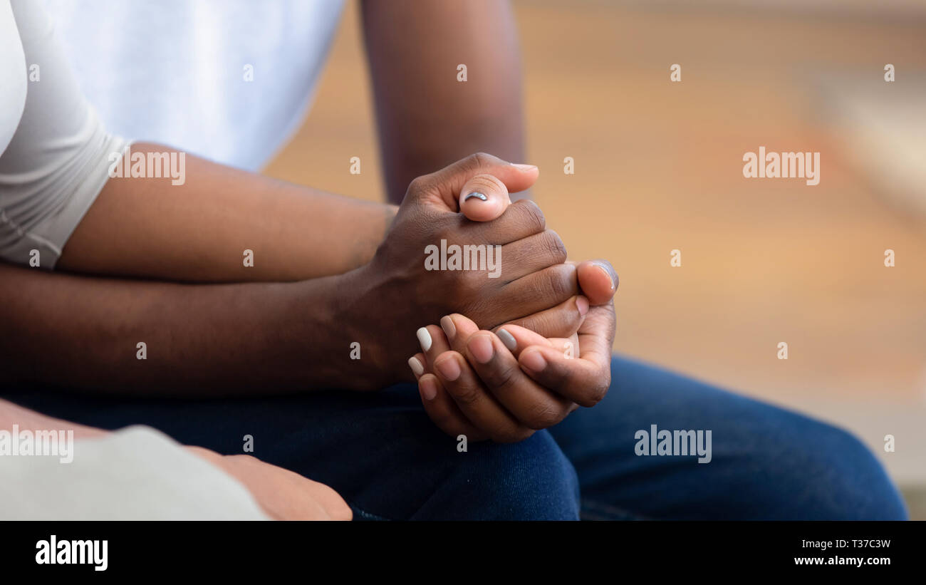 African american family couple holding hands, close up view Stock Photo