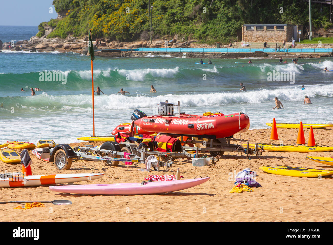 Surf rescue surfboards and red zodiac surf rescue boat on Palm beach in