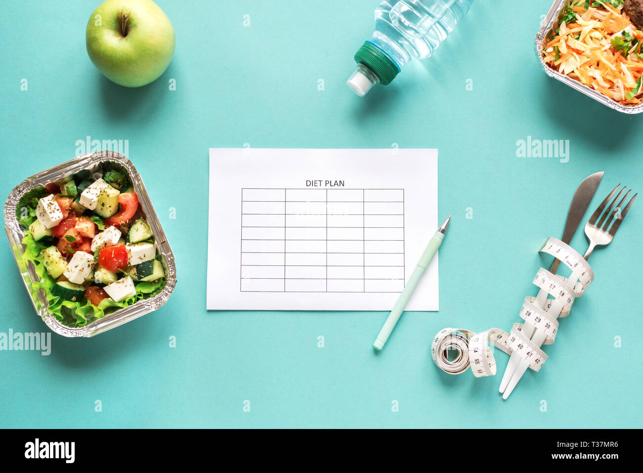 Diet meal plan mockup with healthy food delivery. Fitness nutrition for diet. Daily meals on blue, top view, copy space. Stock Photo