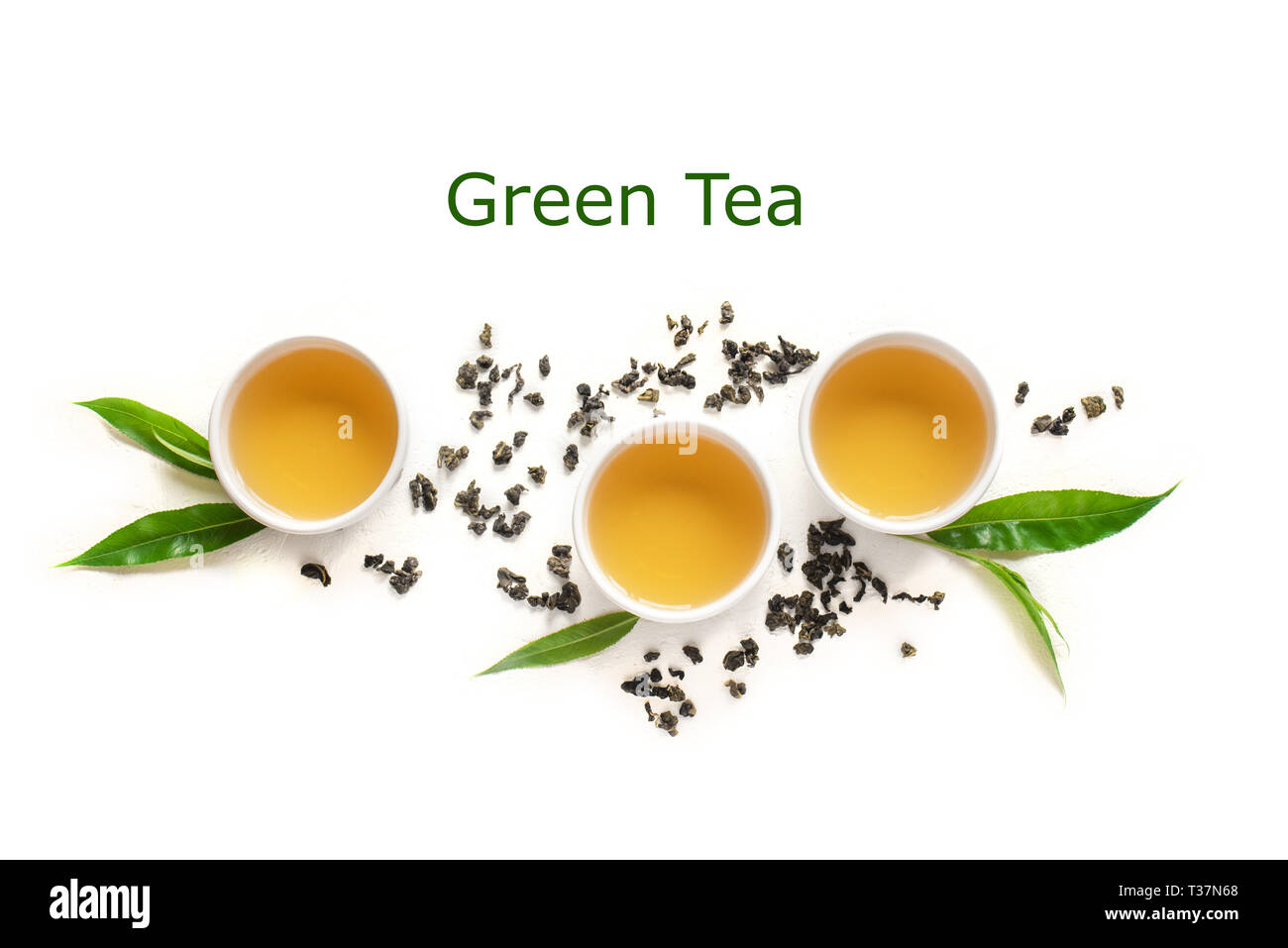 Green tea in ceramic cups, dry green oolong tea and tea leaves isolated