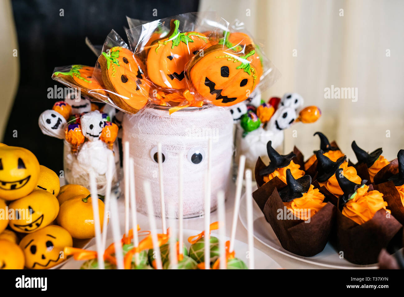 Big decorated jar with pumpkin marshmallows on the candy bar for the  celebration of Halloween Stock Photo - Alamy