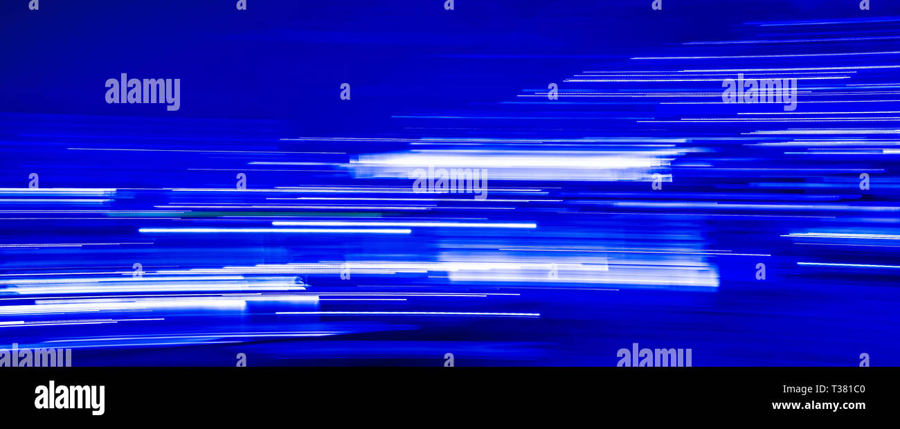Abstract blue light trails on blue background Stock Photo - Alamy
