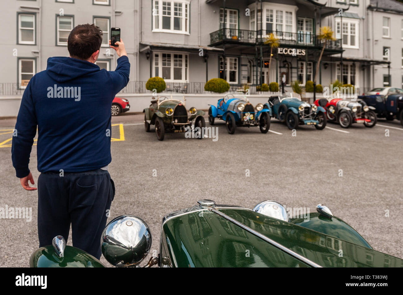 Glengarriff, West Cork, Ireland. 7th Apr, 2019. The French car club 'Amilcar' is currently on a 6 day tour of Ireland.  The club made a stop at the Eccles Hotel, Glengarriff this afternoon. Ian McGregor from Cork took a selfie with a vintage MG. Credit: Andy Gibson/Alamy Live News. Stock Photo
