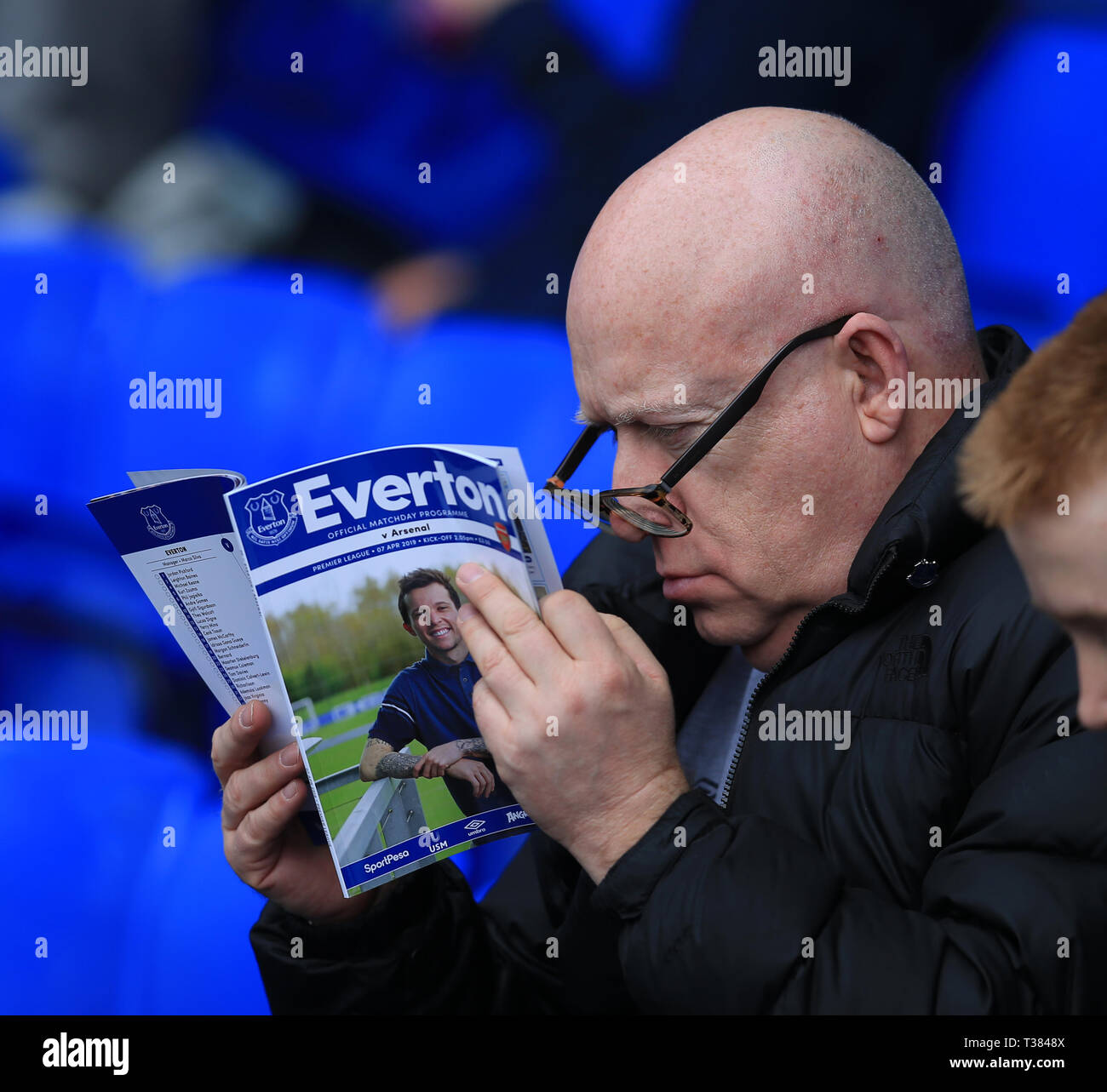Goodison Park, Liverpool, UK. 7th Apr, 2019. EPL Premier League Football, Everton versus Arsenal; an Evertonian closely studies the programme prior to the match Credit: Action Plus Sports/Alamy Live News Stock Photo
