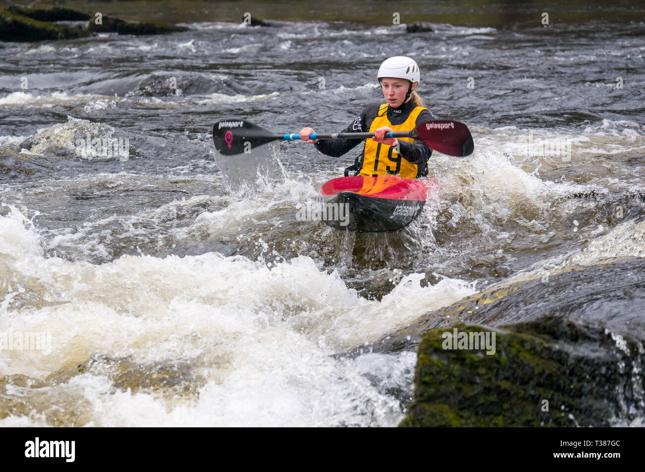 Grandtully, Perthshire, Scotland, United Kingdom, 7 April 2019. Grandtully Premier Canoe Slalom: Olivia Alderson from Holme Pierrepoint Canoe Club competes in the women’s premier kayak on Day 2 on the River Tay Stock Photo