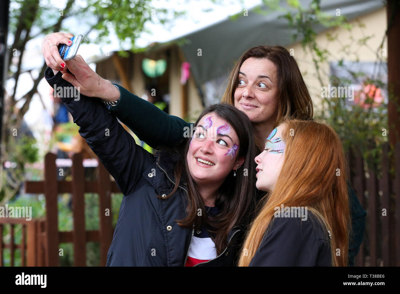 London, UK, UK. 7th Apr, 2019. Spectators are seen taking a selfie before the Oxford vs Cambridge Goat Race in East London.Two pygmy goats compete during the 10th Oxford and Cambridge Goat Race at Spitalfields City Farm, Bethnal Green in East London. The annual fundraising event, which takes place at the same time as the Oxford and Cambridge boat race, where two goats, one named Hamish representing Oxford and the other Hugo representing Cambridge to be crowned King Billy. Credit: Dinendra Haria/SOPA Images/ZUMA Wire/Alamy Live News Stock Photo