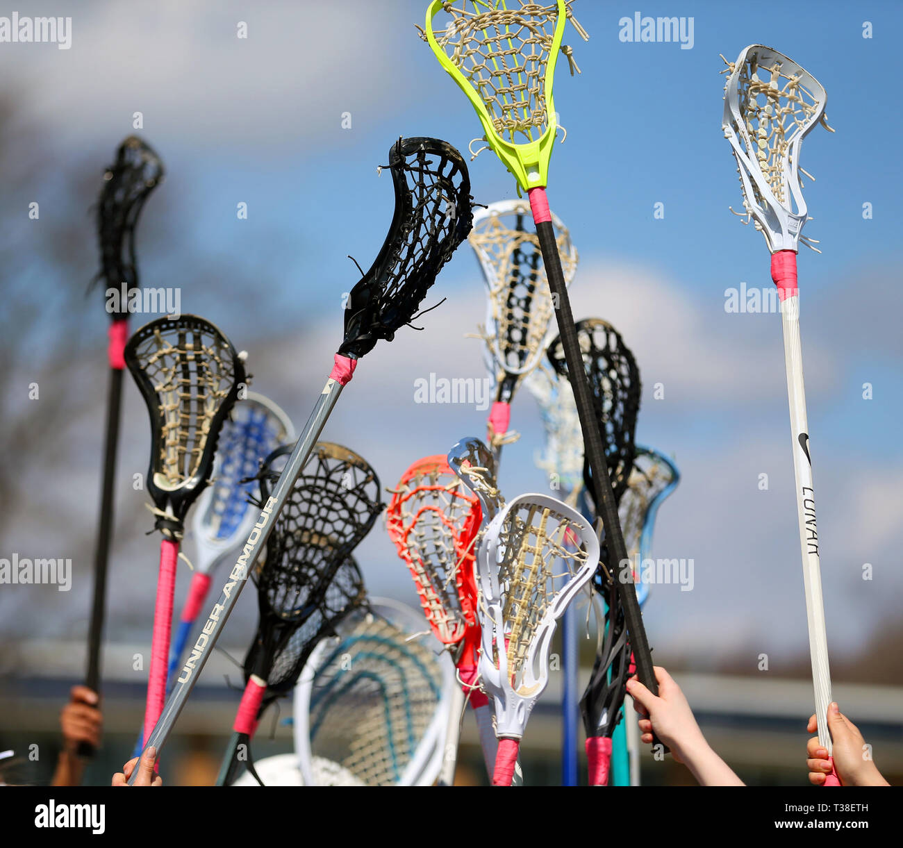 High school lacrosse team raising their sticks prior to a match Stock