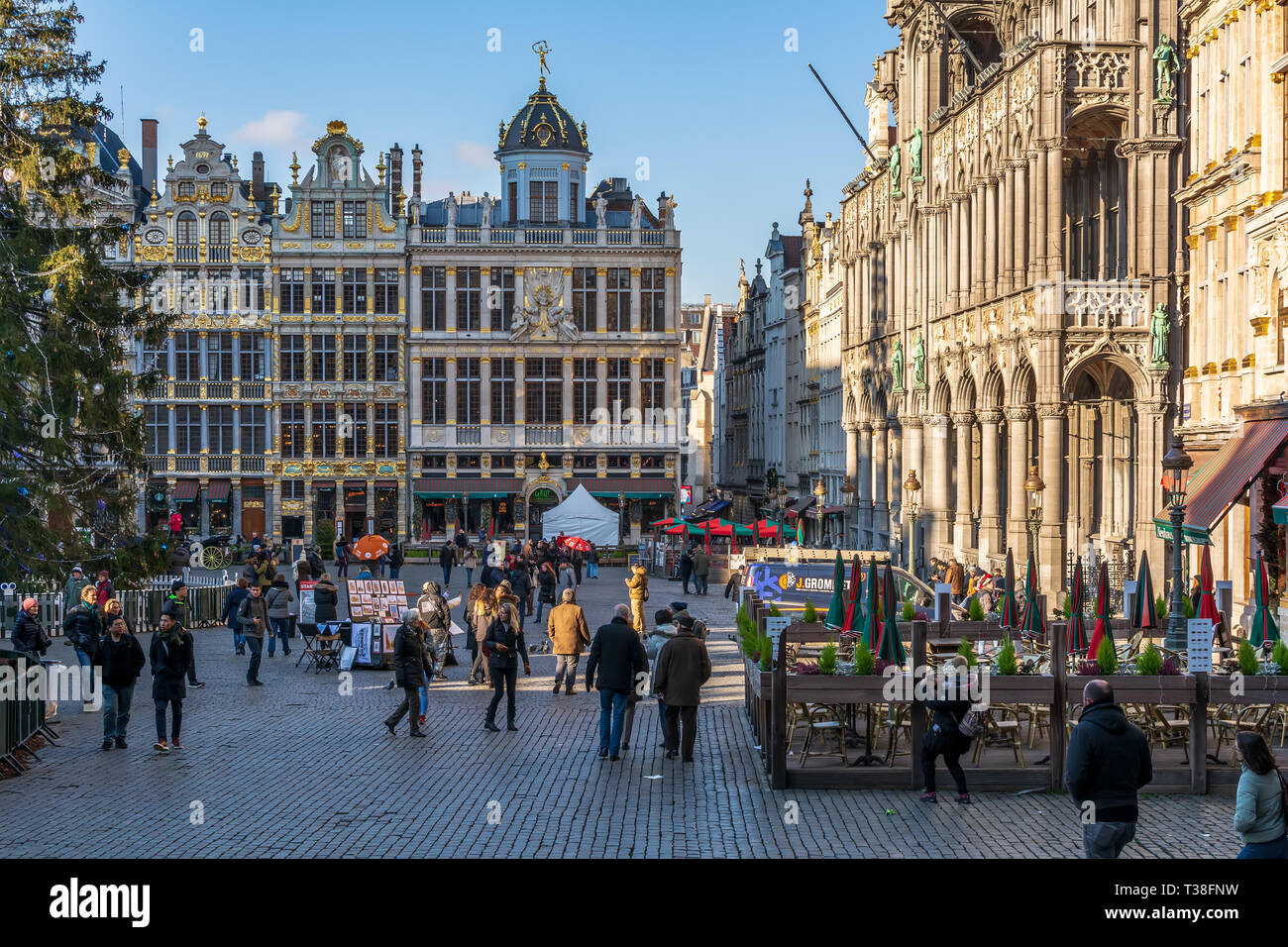 Tourists on the famous Grand Place in Brussels, with rich sculptural decorated guild houses facades and Museum of the City of Brussels aside. Stock Photo