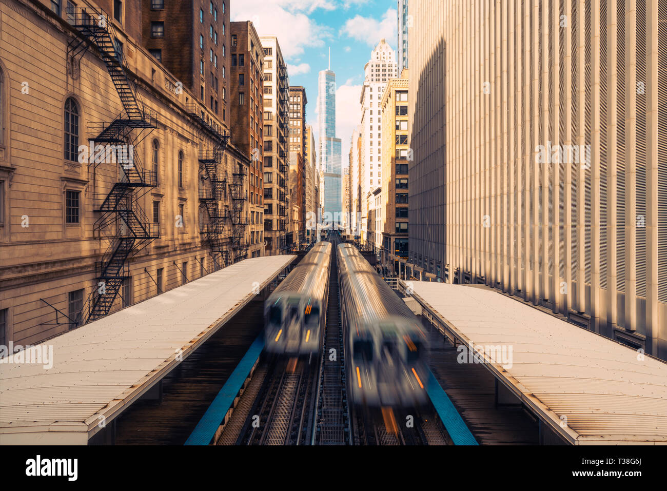 Trains arriving railway station between buildings in downtown Chicago, Illinois. Public transportation, USA landmark, or American city life concept Stock Photo