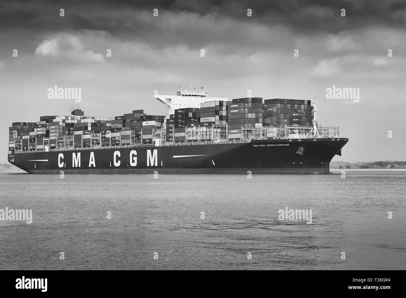 Moody Black And White Photo Of The Giant Container Ship CMA CGM GEORG FORSTER, Leaving The Port Of Southampton. Stock Photo