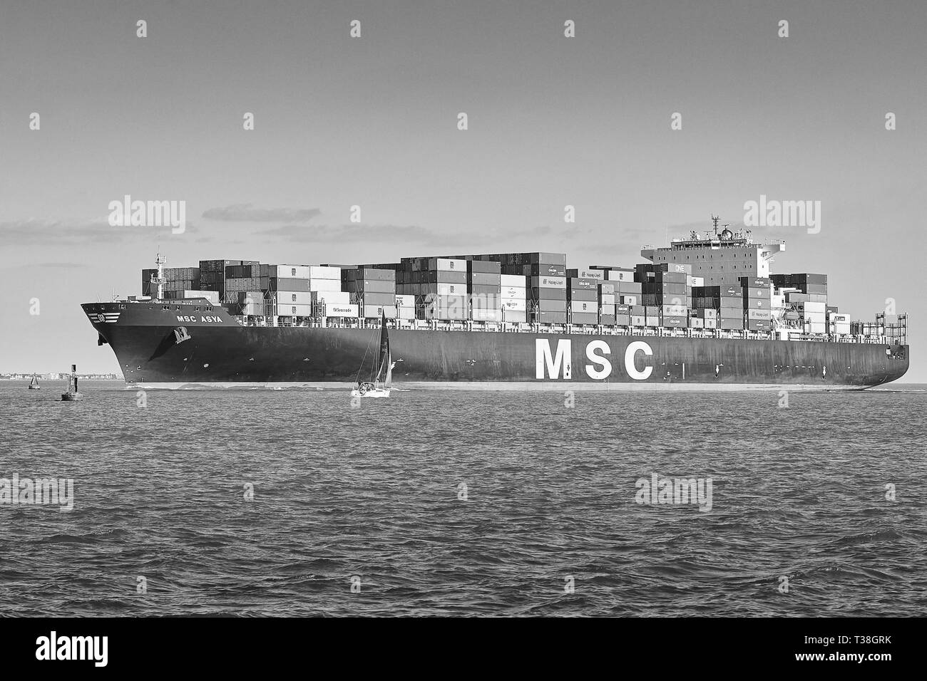 Black And White Photo Of The Container Ship, MSC ASYA, Enters The Deep Water Channel As She Approaches The Port Of Southampton, UK Stock Photo