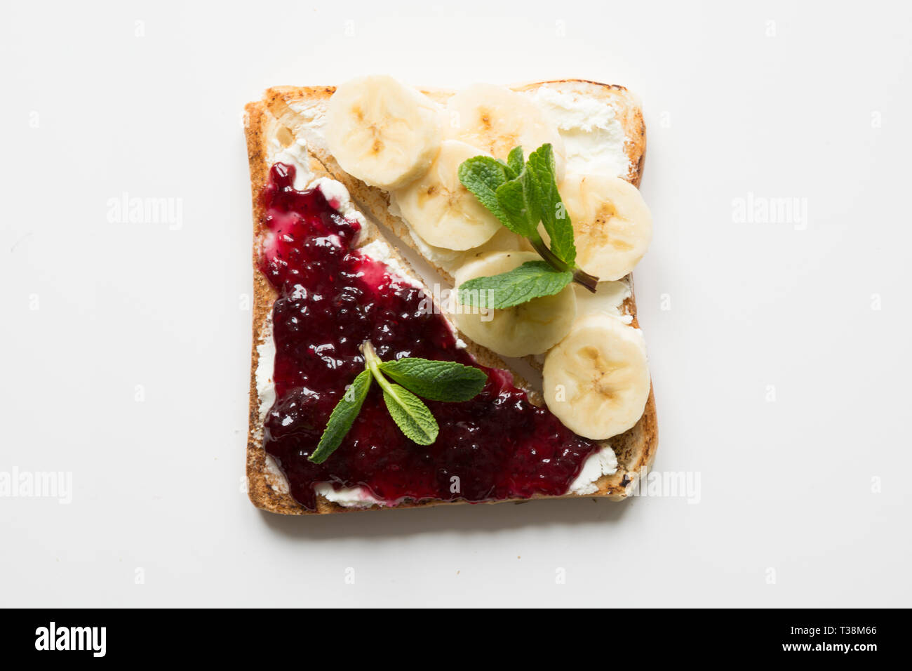 Different types of sandwiches for healthy children's breakfast without sugar, with berry jam, bananas. View from above. Stock Photo