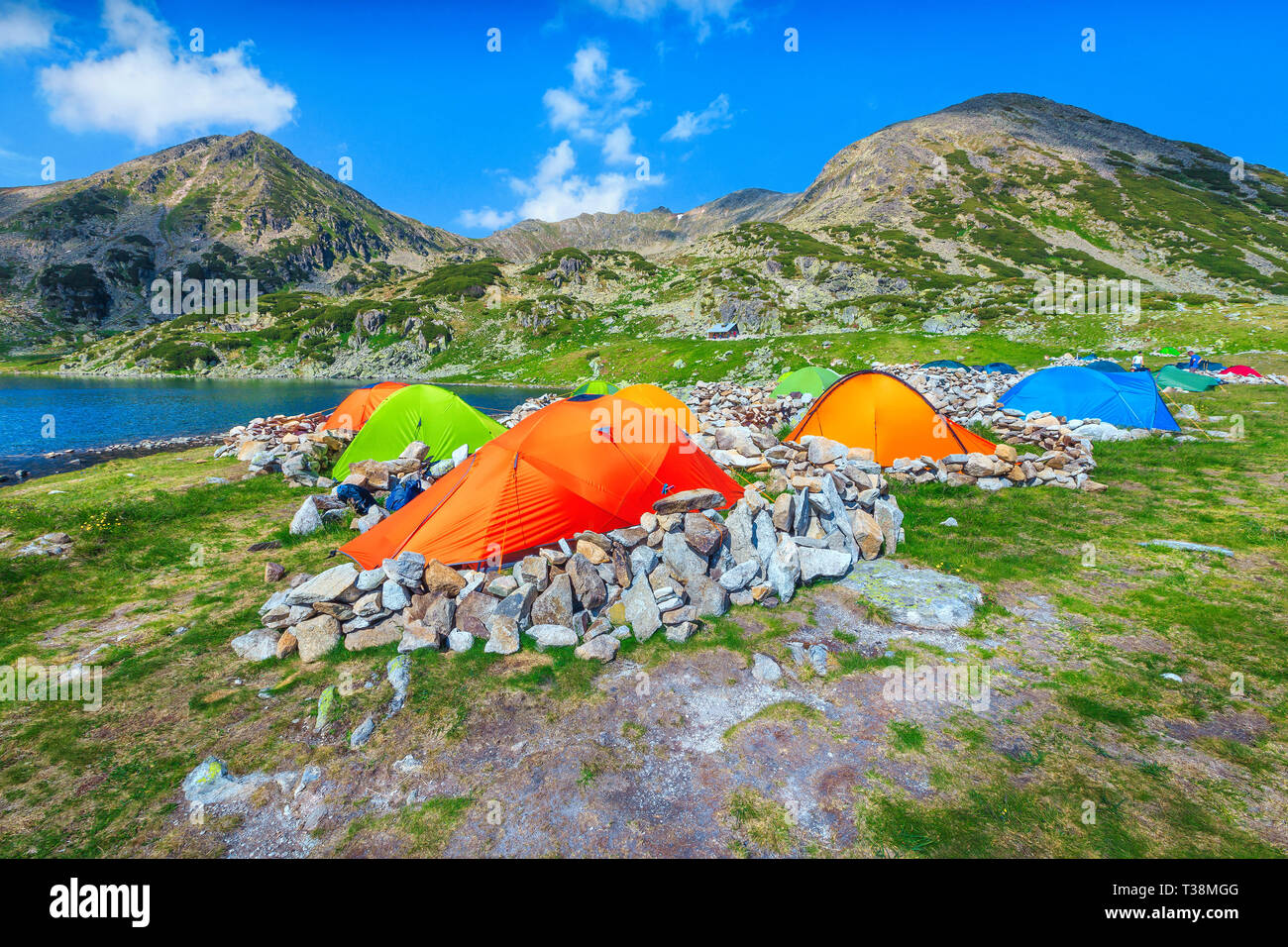 Splendid alpine campground with colorful tents near Bucura glacier lake ...