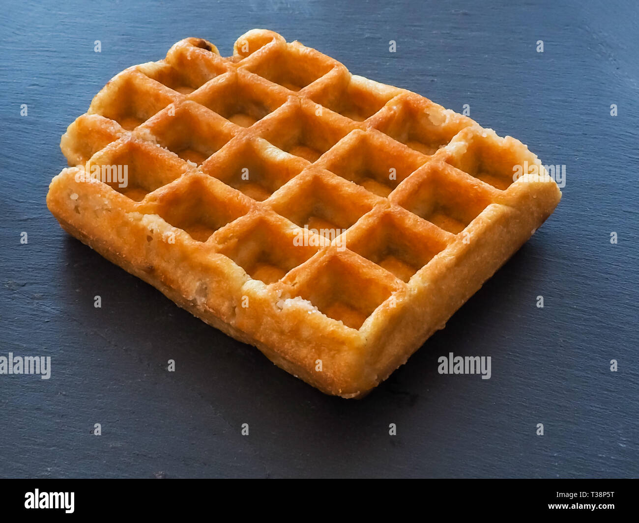 A Belgian waffle on a slate plate Stock Photo