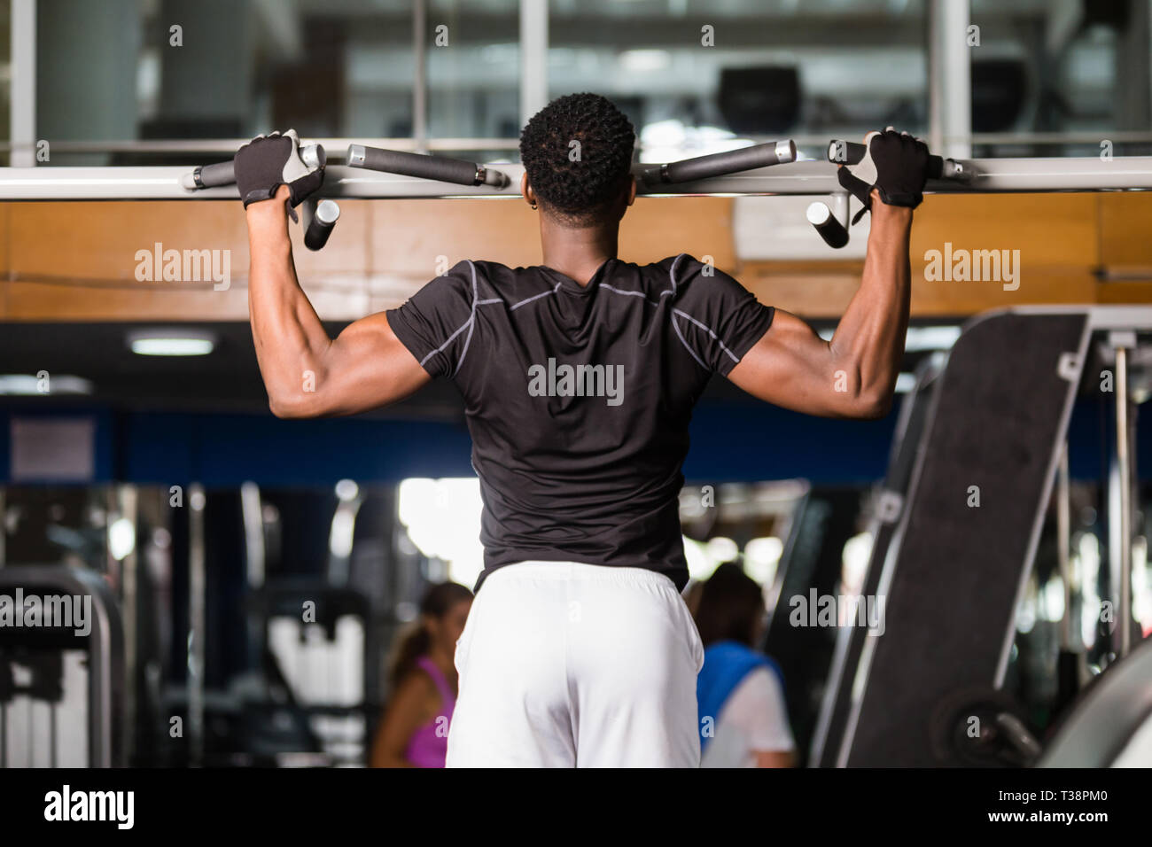 Black African American young man doing pull up workout at the gym Stock ...