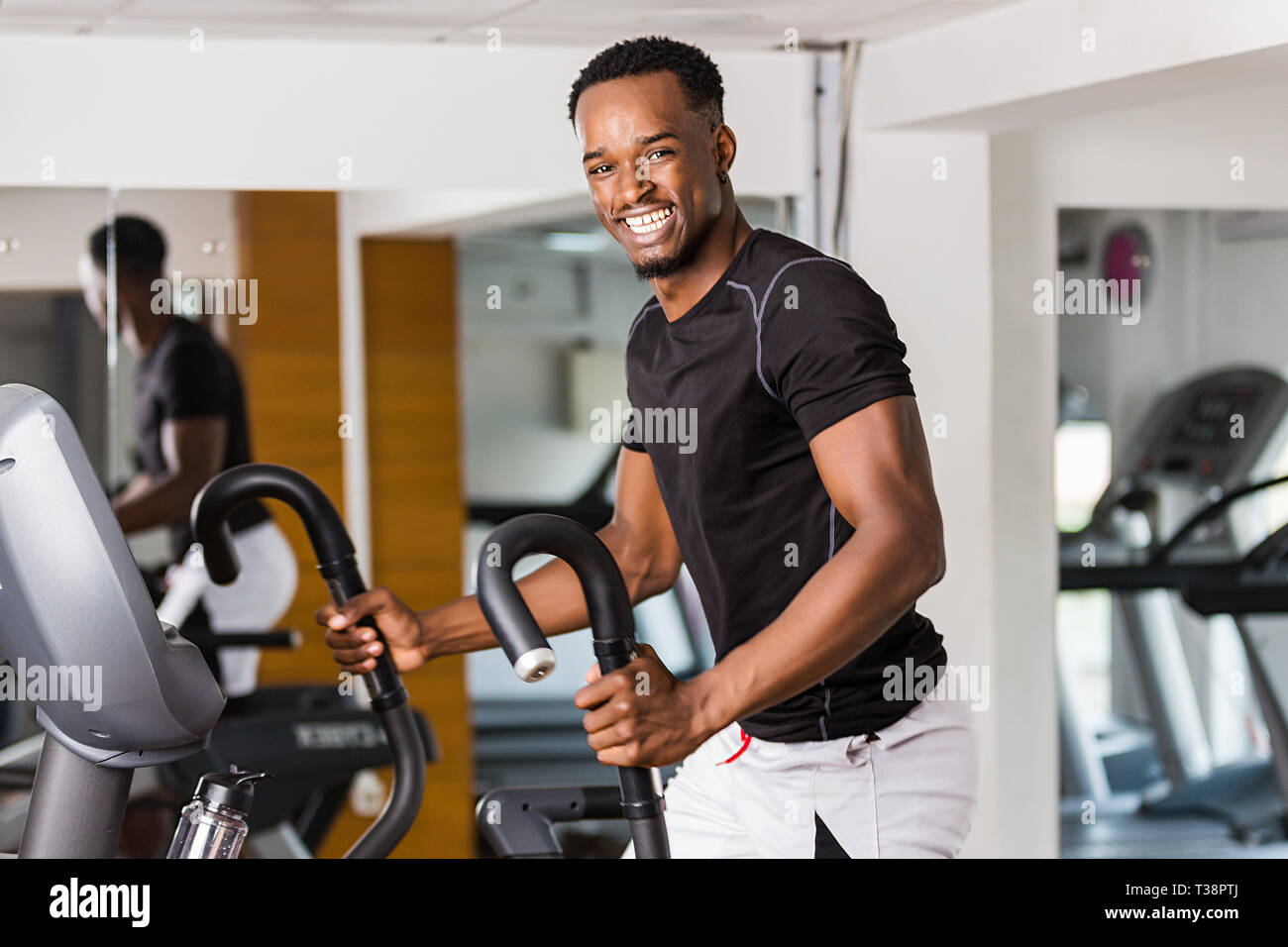 Black African American young man doing cardio workout at the gym Stock ...