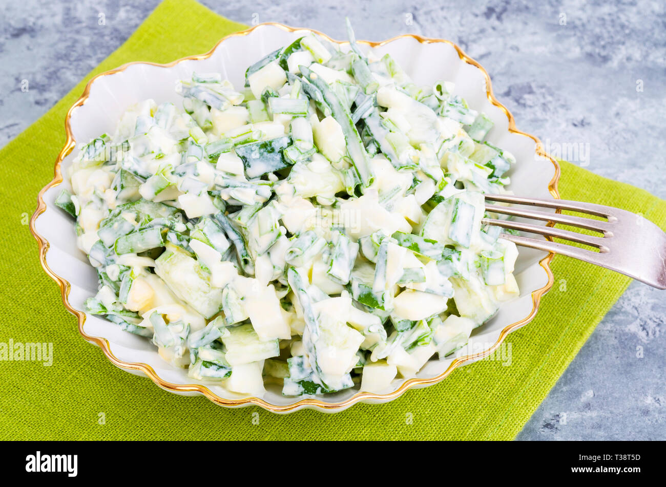 Light dietary egg salad with spring greens, yoghurt dressing. Studio Photo Stock Photo