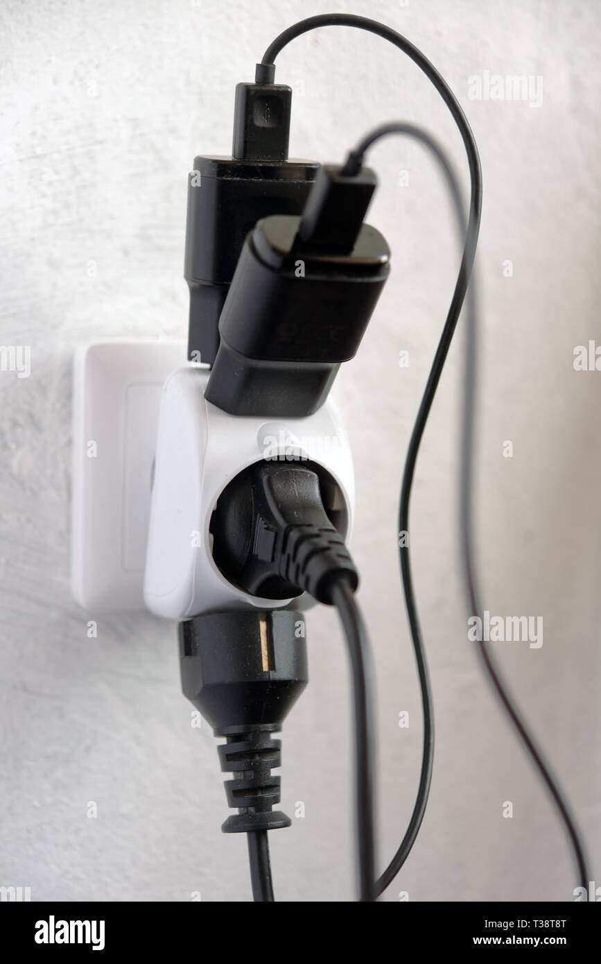 Multiple electric plugs in one power outlet Stock Photo Alamy