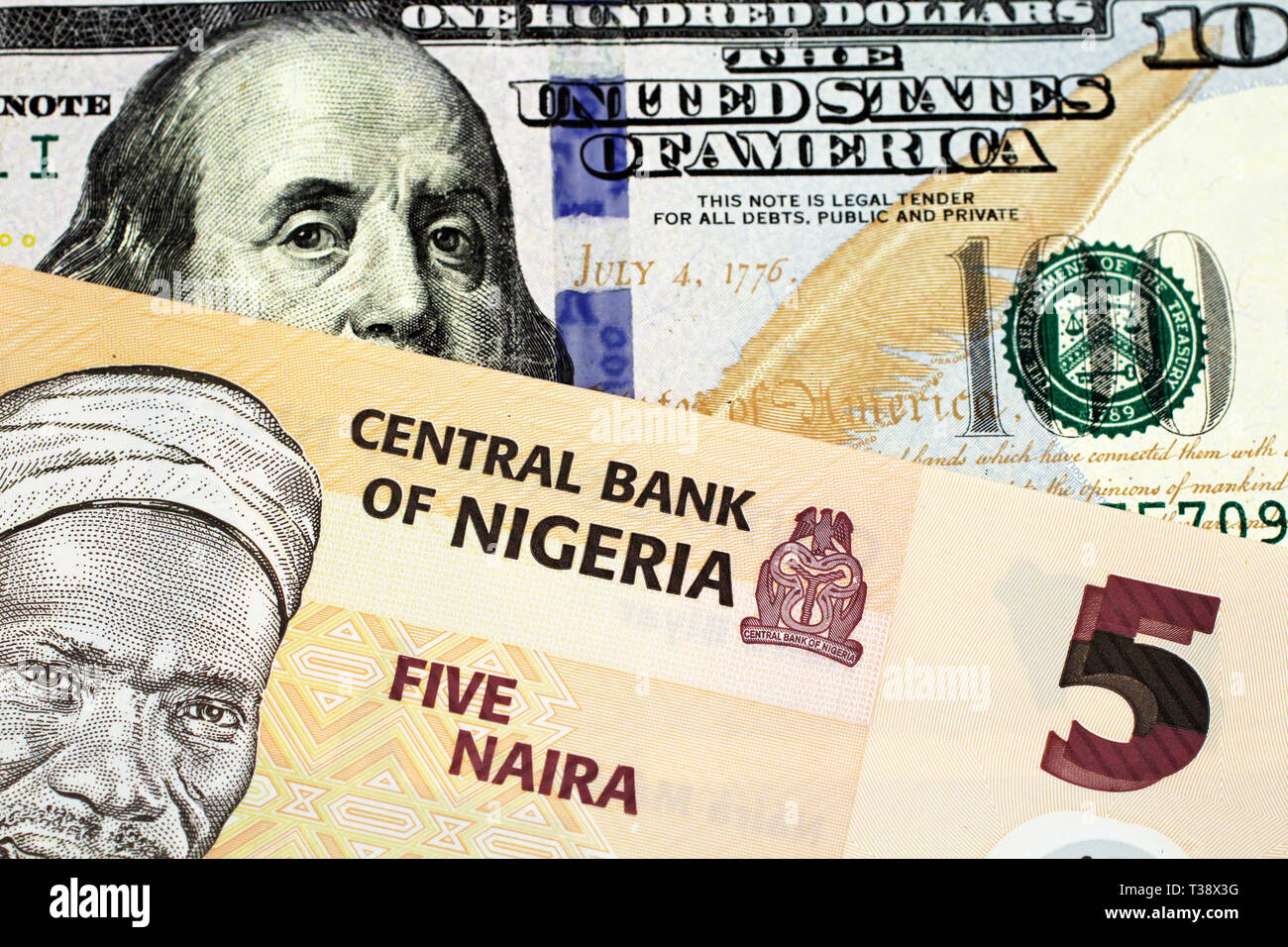 A Macro Image Of A Peach Colored Nigerian Five Naira Bill With An American One Hundred Dollar Bill Close Up Stock Photo Alamy