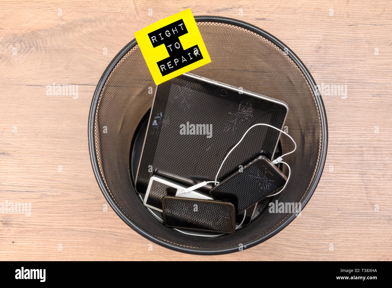 broken smart phones and tablets in rubbish bin with right to repair text, right to repair concept. Stock Photo