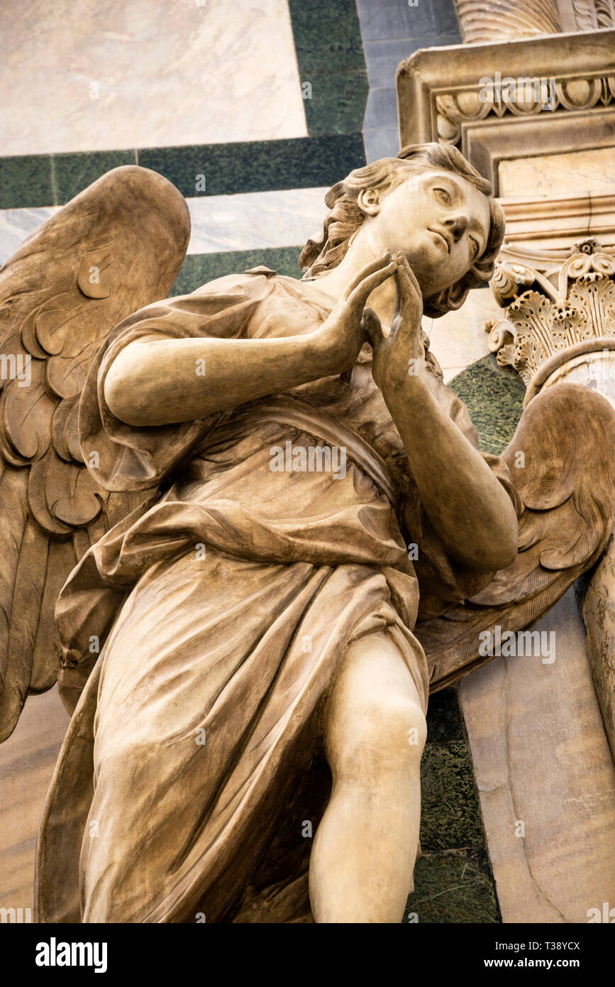 Marble angel statue on the exterior facade of the Florence Cathedral in Florence, Italy on Piazza del Duomo. Stock Photo