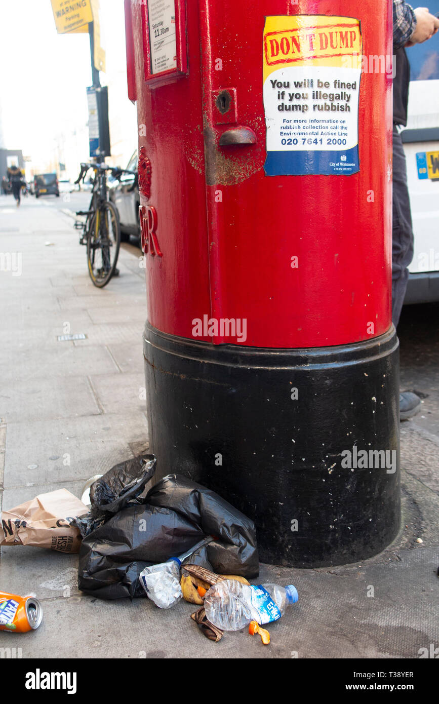 Irony - A dump of rubbish by a letter box under a sign ordering 'Don't Dump' Stock Photo