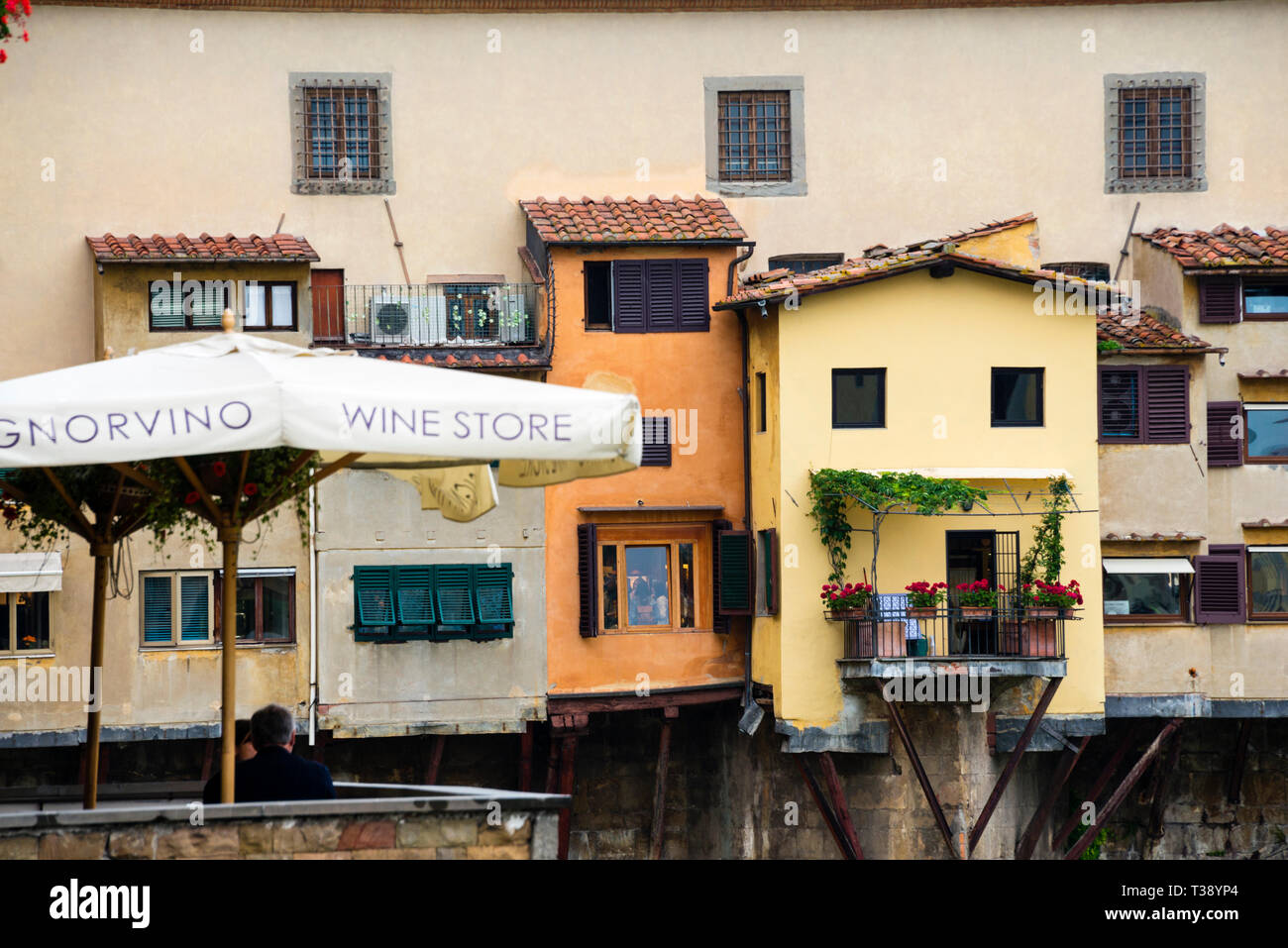 Shops of the medieval Tuscan Ponte Vecchio Bridge and Signorvino Wine Store in Florence, Italy