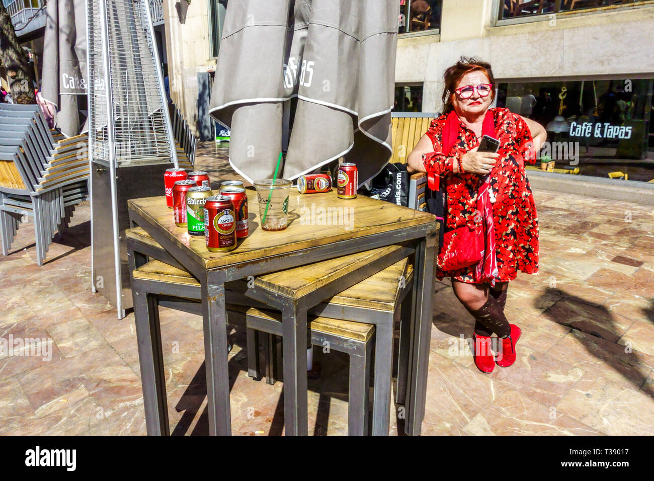 Portrait of woman in red in front of bar Cafe & Tapas, Plaça de l'Ajuntament, Town hall Square, Valencia Spain Europe Stock Photo