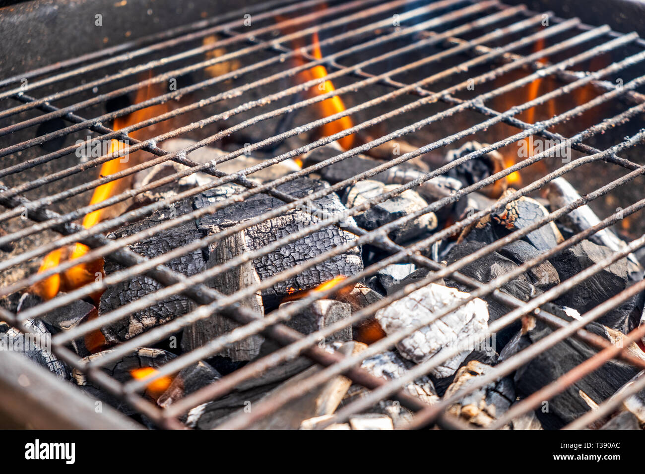 Grill charcoal burning with an open flame isolated Stock Photo Alamy