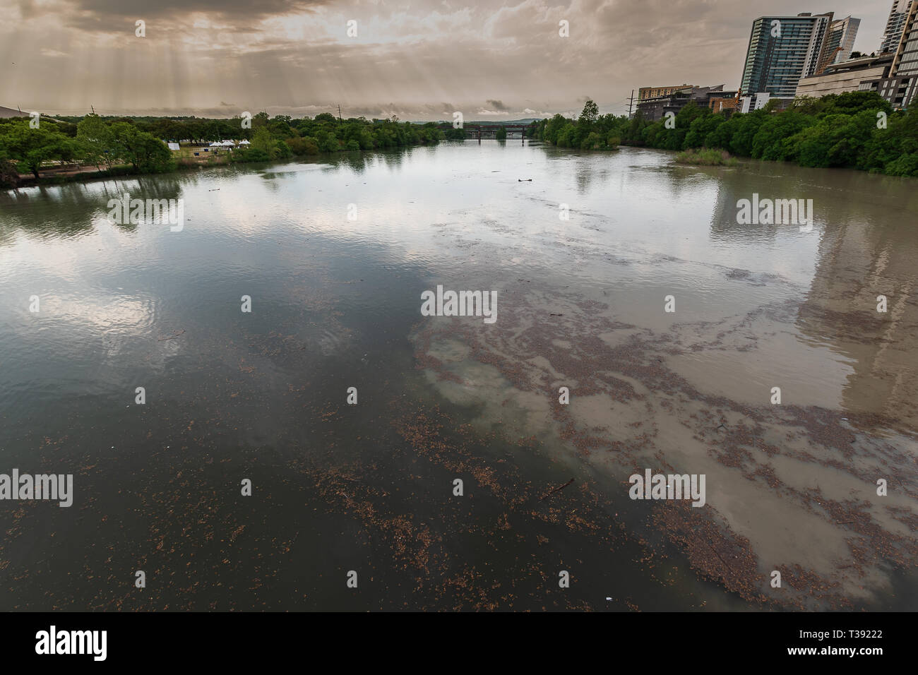 After a day of extremely heavy rains, Lady Bird Lake in downtown Austin, Texas, overflows its banks on to the surrounding walking and biking trails. Stock Photo