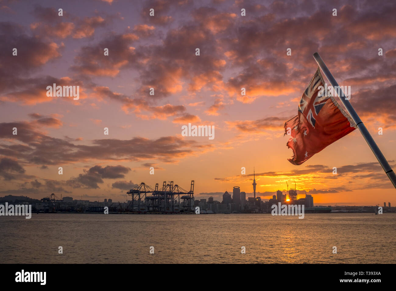 New Zealand red ensign as seen from a boat with Auckland skyline in the background Stock Photo