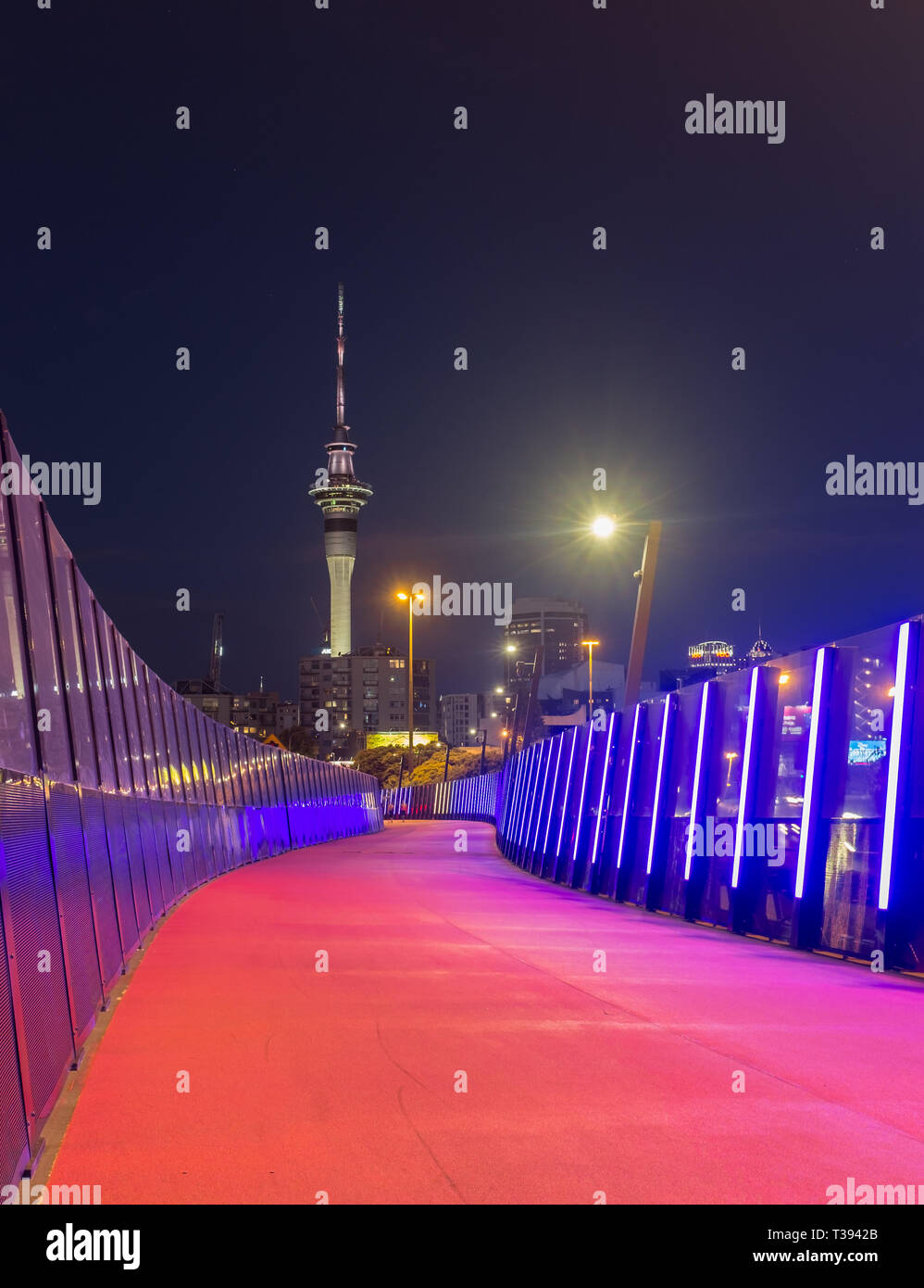 Pink cycle path in Nelson street, with famous Sky Tower in the background in Auckland, New Zealand Stock Photo