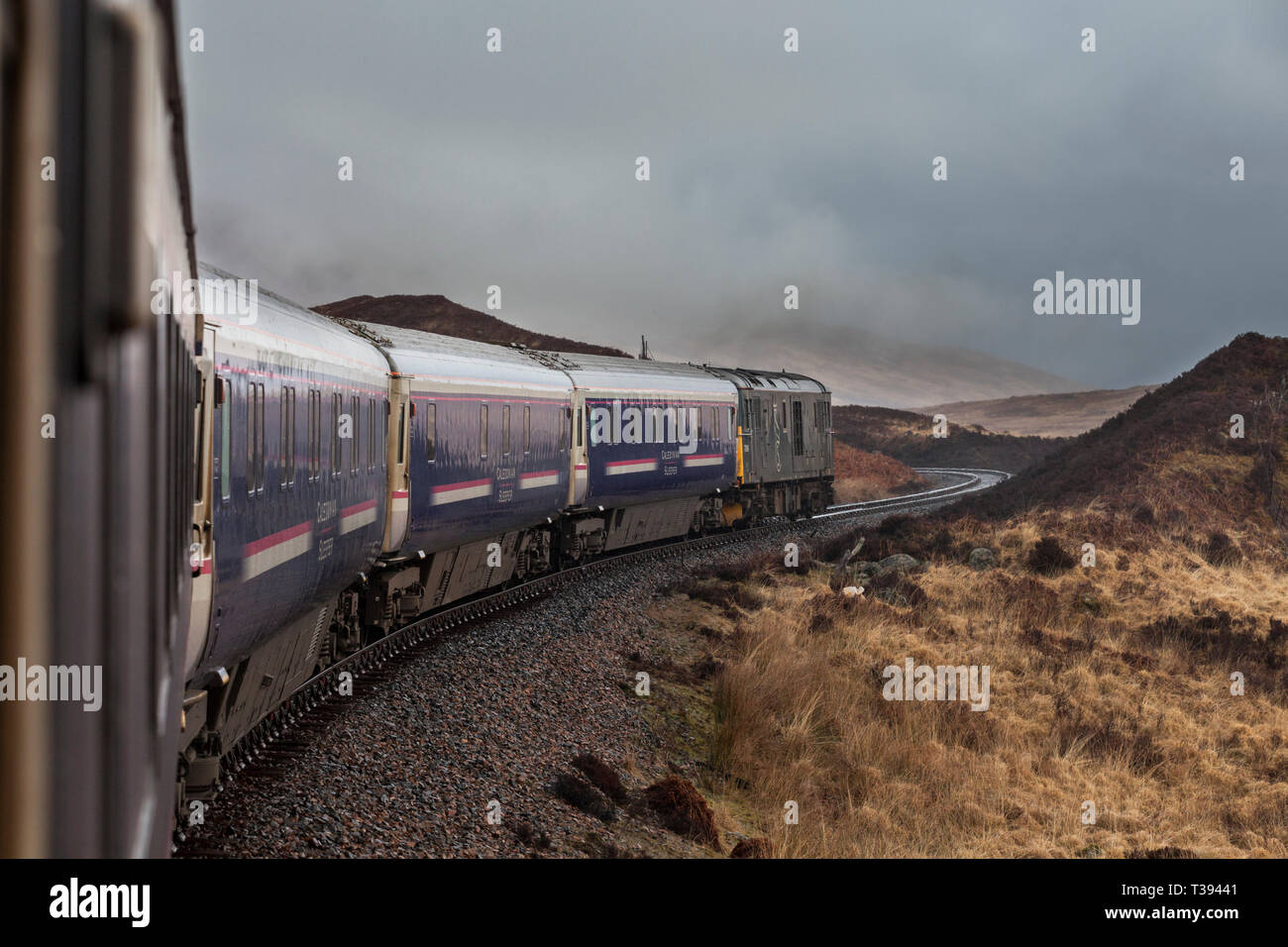 View from the London Euston to Fort William Caledonian sleeper train as it leaves Rannoch on the west highland line in Scotland, hauled by 73969 Stock Photo
