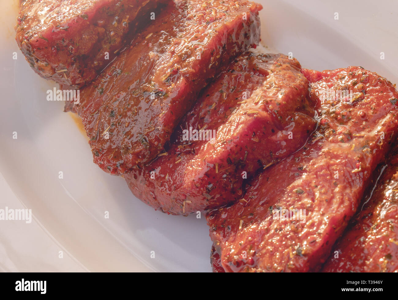 Raw marinated beef steak slices Stock Photo