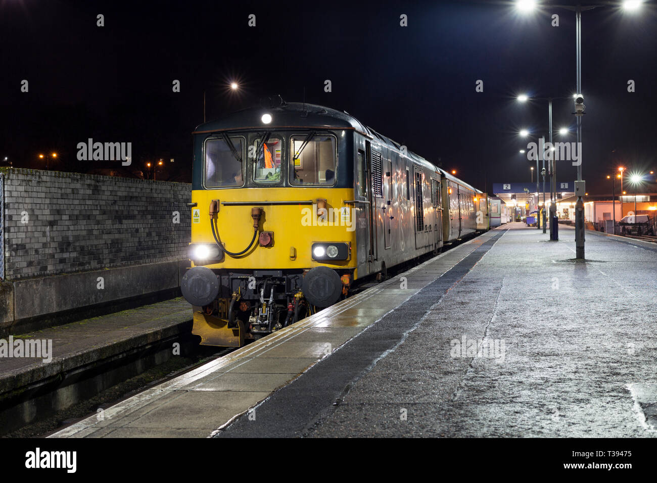 The overnight Caledonian sleeper train from Fort William in the West Highlands of Scotland  to London Euston waits to depart from Fort William. Stock Photo