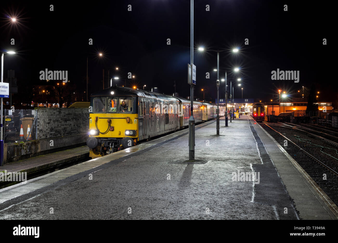 The overnight Caledonian sleeper train from Fort William in the West Highlands of Scotland  to London Euston waits to depart from Fort William. Stock Photo
