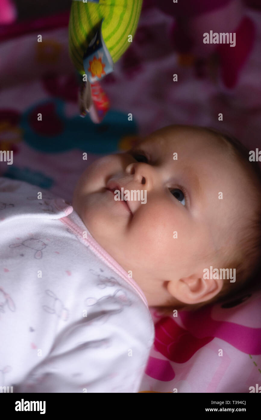 Happy baby laying on a playmat Stock Photo Alamy