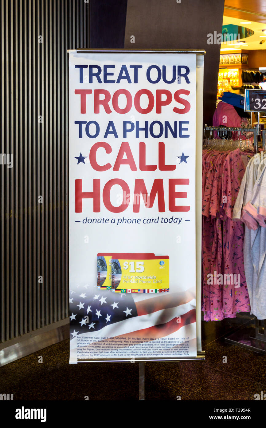 A sign at Seattle airport invites people to Treat Our Troops to a Phone Call Home, by donating a phone card. Stock Photo