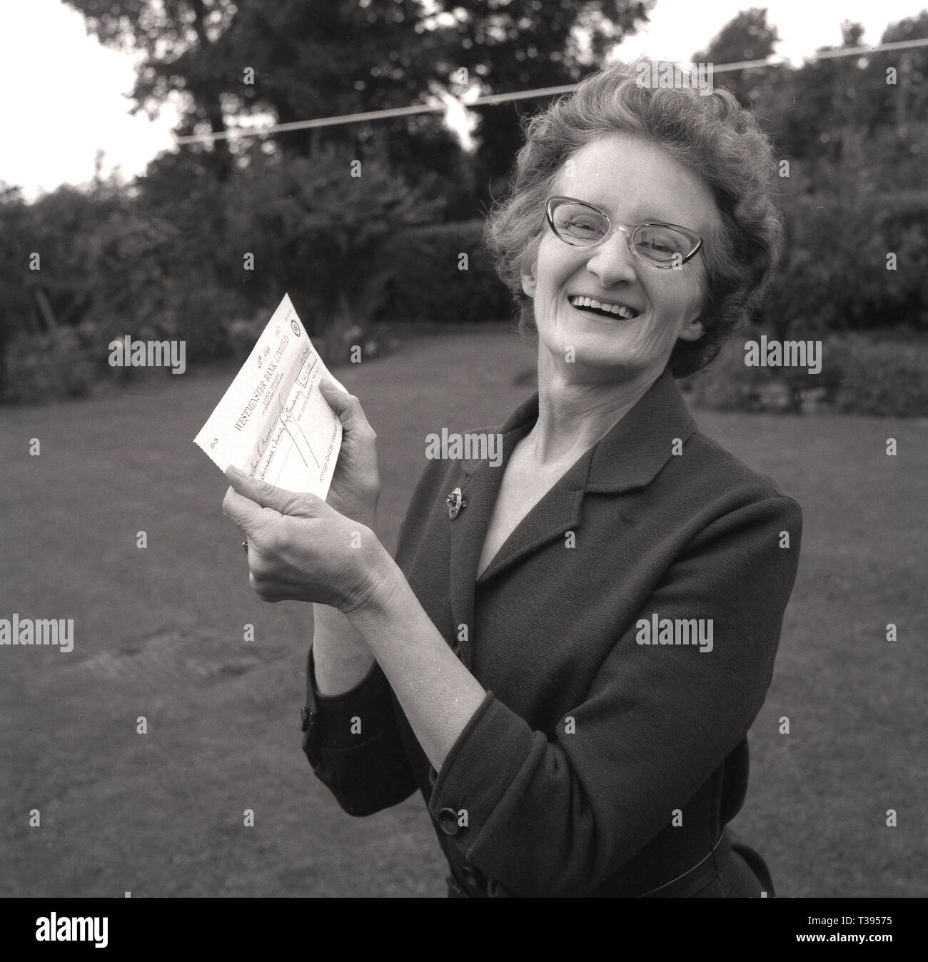 1967, historical, pools winner, a happy lady holding her winners cheque
