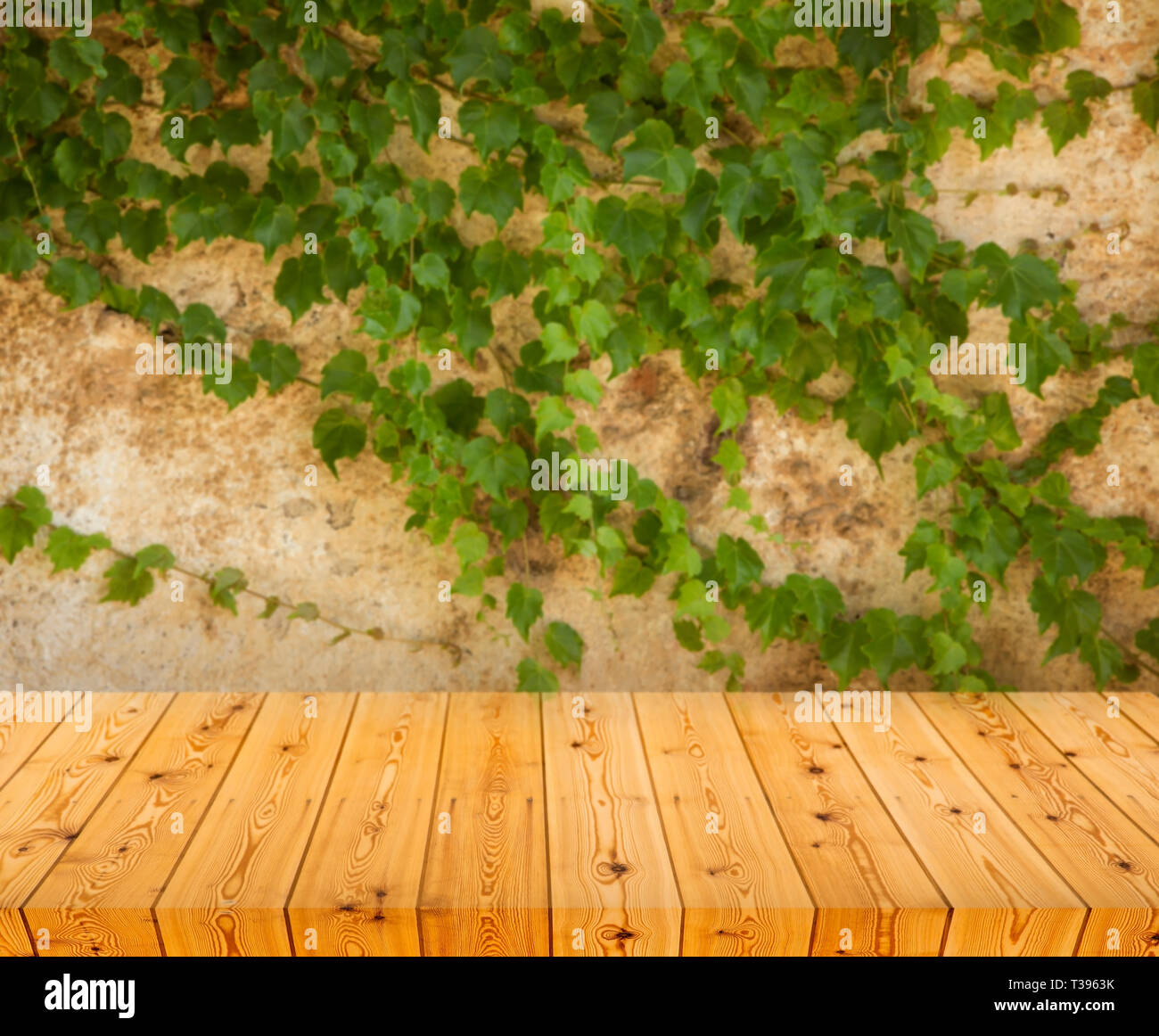 Empty wooden table over grunge wall Stock Photo