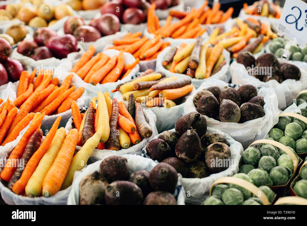 Colorful display of carrots and other produce for sell at a farmers market in Montreal, Quebec. Stock Photo