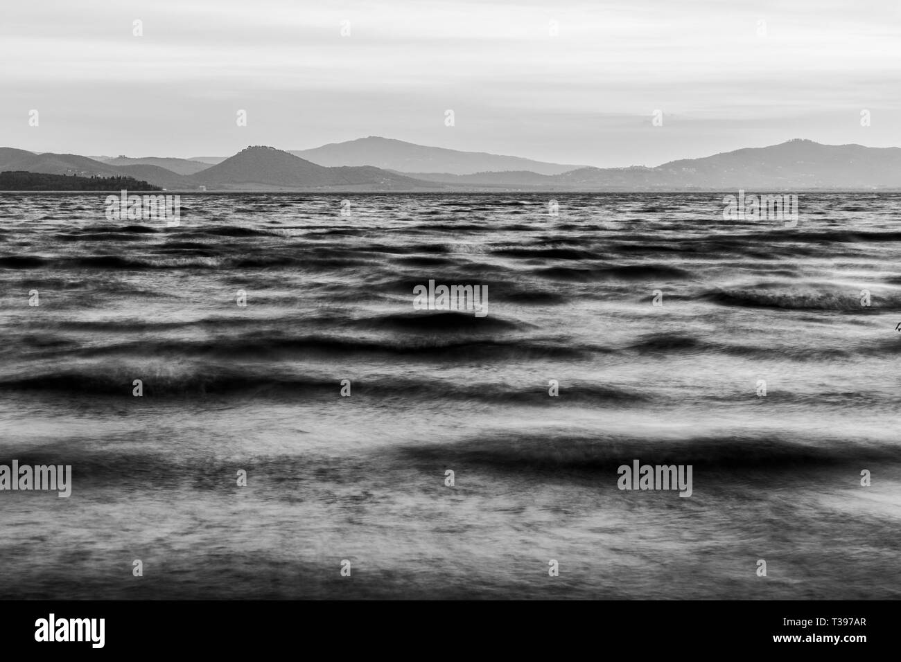 Close view of moving waves on a lake at dusk Stock Photo