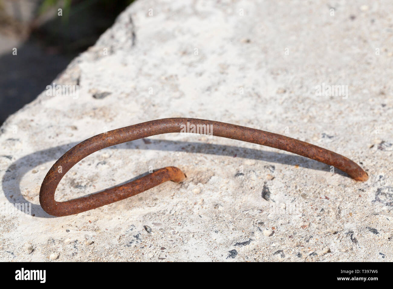 part of old concrete slab with steel hooks for mounting and