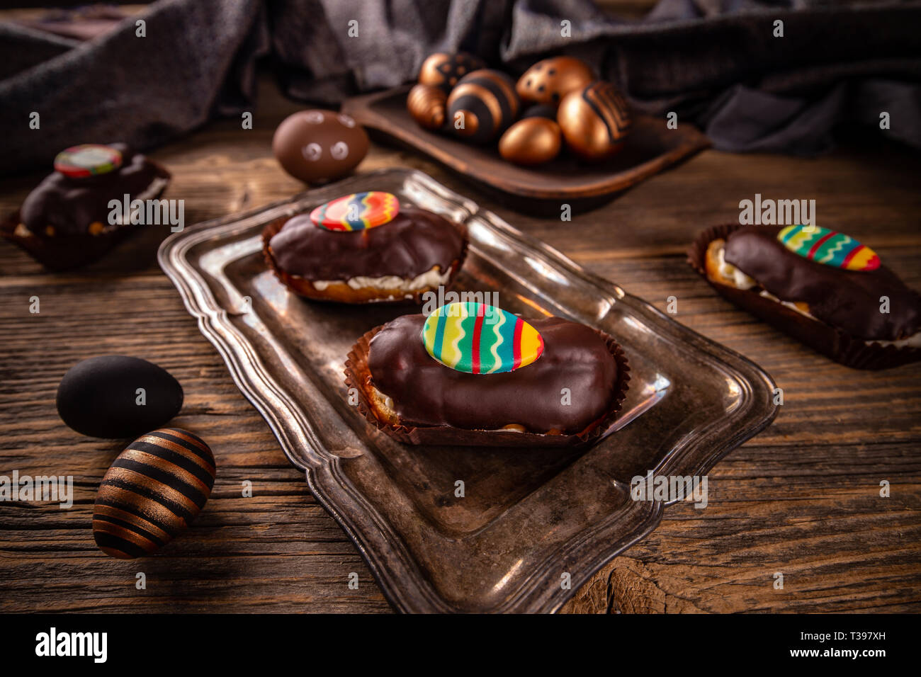 Eclairs with chocolate ganache and Easter decoration Stock Photo