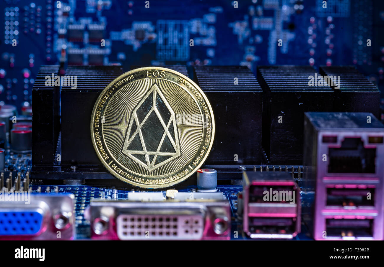 Front view of Eos cryptocurrency over computer video card.Bitcoin mining farm concept. Stock Photo
