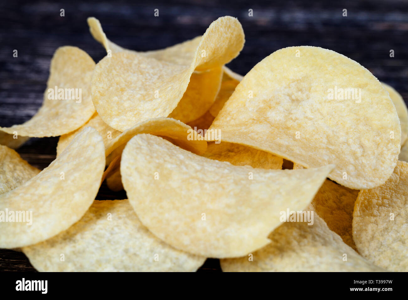 lightcolored thin potato chips made from mashed potatoes, natural to the harmful product on the