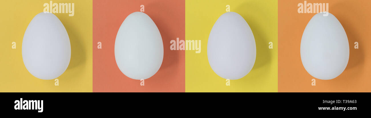 White Easter eggs on a pastel multicolor square background, banner Stock Photo