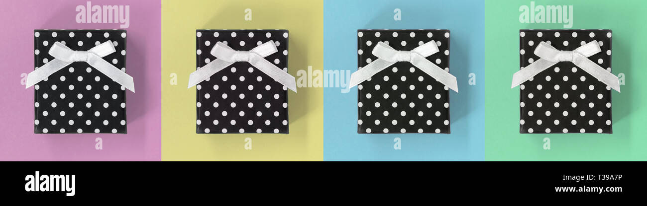 Gift boxes on a pastel multicolor square background, banner Stock Photo