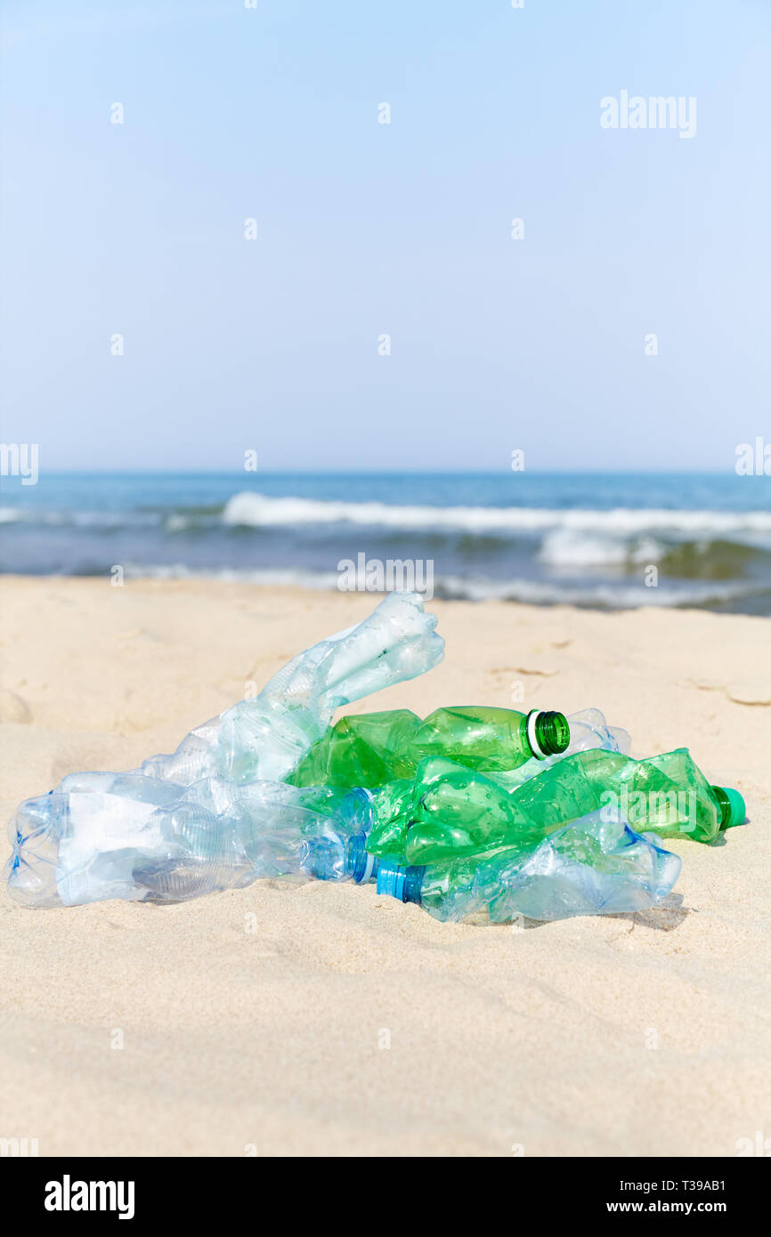 Used plastic bottles on a beach, selective focus. Stock Photo